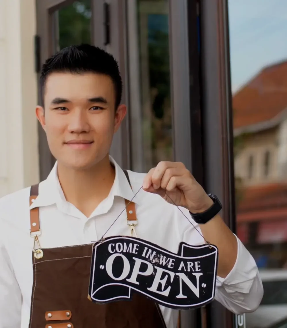 Waiter Holding Sign Come In We Are Open