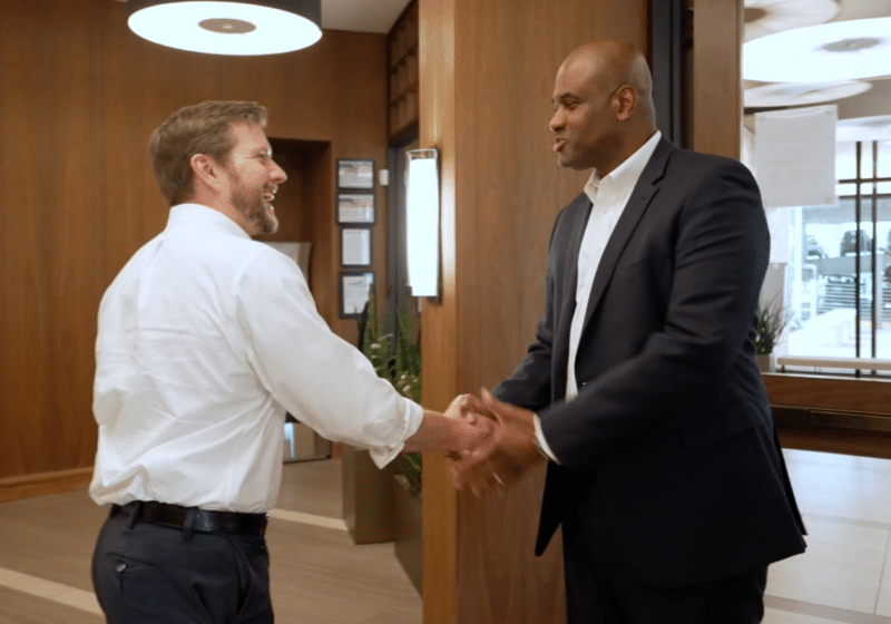 Innovation Magnet - Two Guys Talking inside of Modern Building - TBA